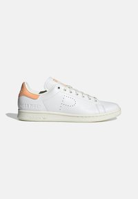 White leather sneaker with orange accents, featuring “MISS PIGGY” embossed on the heel, round toe, and classic lace-up design.