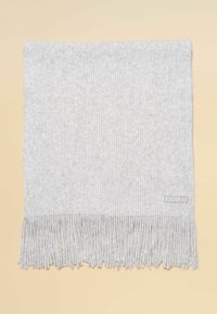 Šedý rebrovaný pletený šál s strapcovými okrajmi. Na boku má malú štítok s nápisom „JOULES“. Jemná textúra, obdĺžnikový tvar.