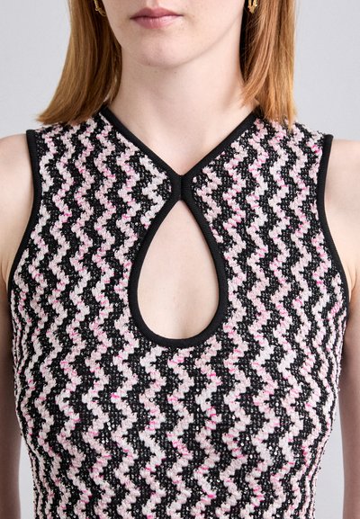 Black, pink, and white sleeveless top with a zigzag pattern, featuring a keyhole neckline and textured material. Edges are trimmed in black.