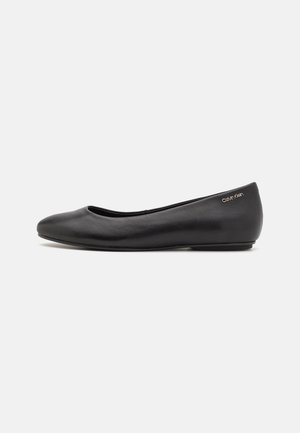 Black leather ballet flat with rounded toe, low heel, and small Calvin Klein logo near the heel on a white background.