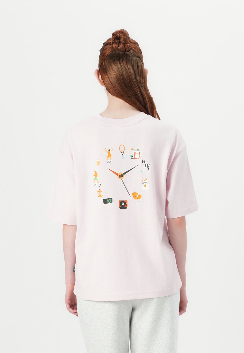 Light pink cotton t-shirt with short sleeves, featuring a colorful clock design on the back, incorporating various playful icons.