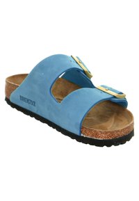 Blue suede slide sandal with two adjustable straps, cork footbed, and textured black rubber outsole. Brand name "Birkenstock" visible.