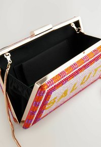 Beaded clutch bag with a metallic frame, featuring a colorful design in pink, orange, and white, and a black fabric interior.
