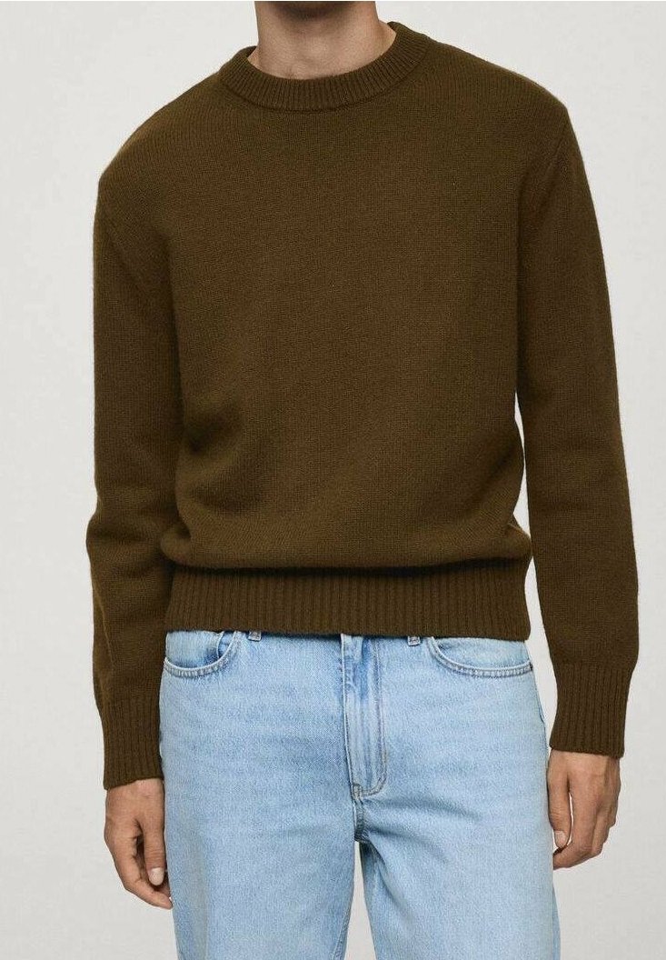 Brauner gestrickter Pullover mit geripptem Rundhalsausschnitt und Saum, kombiniert mit hellblauen Jeans, die die Textur und die taillierte Passform betonen.