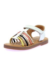 Sandalia blanca de cuero con correas de colores (rosa, amarillo, negro, dorado) y cierre de velcro. Diseño abierto con suela plana y texturizada.