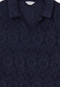 Polo shirt navy textured con un motivo in rilievo, caratterizzato da un colletto e un'apertura a forma di V. Il materiale sembra morbido e accogliente.