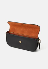 Black leather clutch bag with gold snap closure, open to show orange suede interior and zippered pocket inside.