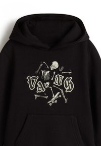 Svart huvtr Överdel med en skelettgrafik och texten "VANS" i stiliserad vit font. Känguruficka fram, mjuk t.ex. textur.