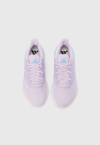 Zapatillas deportivas de color púrpura claro con una parte superior de malla texturizada, cordones planos, detalles en azul claro y un logo negro en la lengüeta.