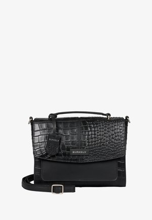 Sac à main noir en matériau texturé imitant le crocodile, avec une partie inférieure lisse. Équipé d'une bandoulière amovible et d'une étiquette avec logo.