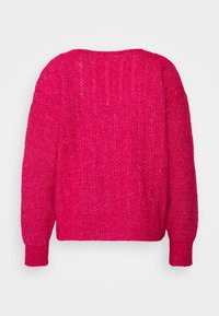 Pink knitted sweater featuring a ribbed pattern, dropped shoulders, and a wide crew neck. The fabric has a soft, textured finish.