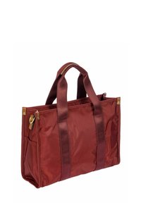 Sac en toile maroon rectangulaire avec des poignées renforcées, des poches latérales et des accents en métal doré sur fond blanc.