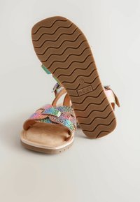 Multicolored sandals with a textured pattern, adjustable straps, and a cushioned insole. The rubber sole features a wave pattern for traction.