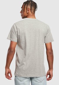 Gray cotton t-shirt with short sleeves and a crew neck, featuring a relaxed fit and smooth texture, shown from the back.