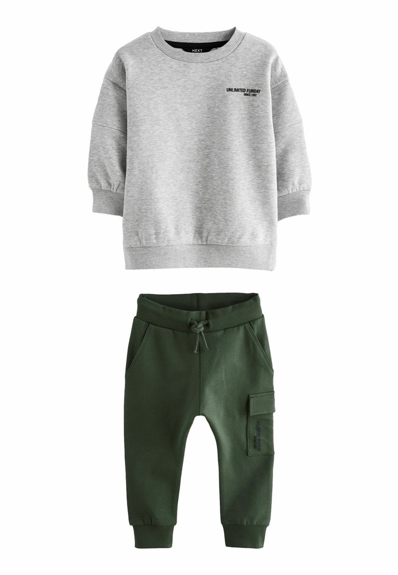 Gray sweatshirt with long sleeves, ribbed cuffs, and black printed text. Green jogger pants with elastic waist, side pockets, and cargo pocket.