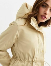 Beige waterproof jacket with a hood, drawstring waist, snap and zipper closures, and visible stitching details. Smooth, textured fabric.