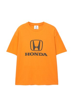 Narancssárga pamut póló fekete Honda logóval és felirattal a középen. Rövid ujjú és kerek nyakú; laza szabású.