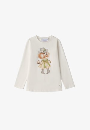 Camisa de algodón blanca de manga larga con un gráfico de un perro con un sombrero de puntos, vestido y botas decorativas, con un acento de cinta verde.