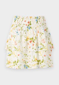 Jupe blanche à volants avec taille smockée et imprimé floral coloré dans des tons verts, jaunes, bleus et orange sur fond uni.