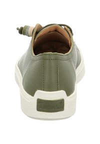 Olive green leather sneaker with a white textured sole, featuring a looped lace detail at the back and soft tan lining inside.