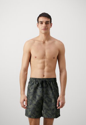 Black swim shorts with a green leaf pattern, featuring an elastic waistband and drawstring, made from lightweight fabric.