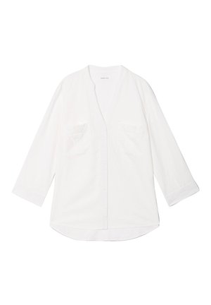 Camicia bianca in cotone a maniche lunghe con scollo a V, dotata di due tasche sul petto e vestibilità comoda. Presenta una chiusura con bottoni e un orlo arrotondato.
