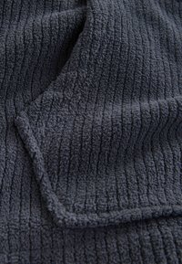 Dark gray textured fabric with a ribbed pattern, featuring a soft, plush surface. Edges are neatly finished for durability.