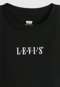 Black cotton T-shirt with a crew neckline and white embroidered "LEVI'S 1873" logo centered on the chest. Soft texture, casual design.