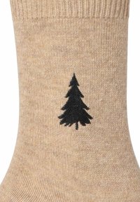Gestrickte Socken in hellem Beige mit einer weichen Textur, seitlich mit einem schwarzen Baum-Motiv. Die Bündchen sind gerippt für zusätzlichen Halt.