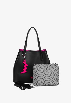 Schwarze Leder-Tote-Bag mit strukturiertem Design, rosa Reißverschlussanhänger und Logodetail. Modell trägt eine Jeansjacke und einen hellrosa Rock.