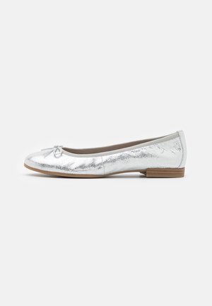 Silver metallic ballet flat shoe with small bow on toe and low stacked wooden heel, side view on white background.