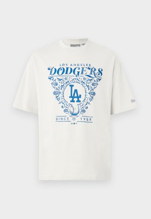 Biela bavlnená tričko s modrým grafickým textom "LOS ANGELES DODGERS" a "SINCE 1958" s kvetinovými akcentmi a logom "LA" v strede.