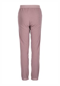 Light pink sweatpants made of soft fabric, featuring a ribbed waistband and cuffs, with a smooth texture and no visible patterns.