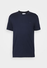 Navy blue cotton T-shirt with a crew neckline, short sleeves, and a subtle embossed logo on the chest. Smooth texture, simple design.
