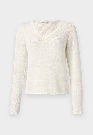 V nyakú, hosszú ujjú pulóver tört fehér kötött anyagból. Lazán omló fazon, texturált minta, és egyszerű szegés jellemzi. Könnyű anyag.