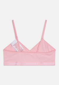 Világos rózsaszín bralette vékony pántokkal, háromszög alakú dizájnnal és puha anyagtextúrával. Kontrasztos fehér "CONVERSE" logós övvel rendelkezik.