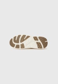 Shoe sole with a white base and brown textured patterns. Features a honeycomb design and grooves for traction.