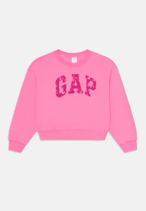 Sweat à capuche fuchsia avec des poignets et un ourlet côtelés. Logo "GAP" dans une teinte plus sombre avec un motif floral au centre. Encolure ronde.