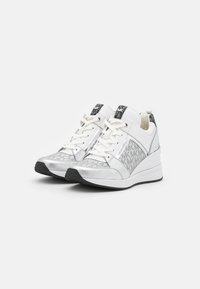 Sneakers bianchi con accenti argentati e pannelli testurizzati, caratterizzati da una finitura metallica, lacci frontali e una suola in gomma nera.