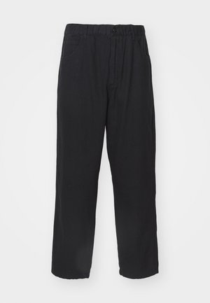 Black cotton trousers with a relaxed fit, featuring an elastic waistband, front pockets, and no visible patterns or embellishments.