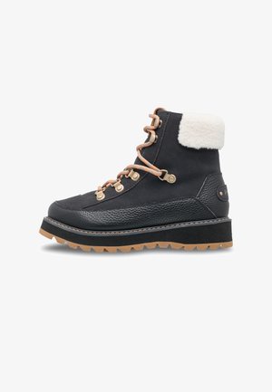 Black ankle boot with a textured leather lower, suede upper, fur collar, and orange laces. Features a thick rugged sole for traction.