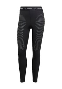 Leggings noirs au design ajusté, avec une taille TECHFIT et une texture lisse. Des motifs sur les côtés dans une teinte plus foncée créent un intérêt visuel.