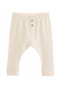 Pantalon pour bébé de couleur crème avec une ceinture élastique et deux boutons en bois sur le devant, fabriqué en tissu doux.