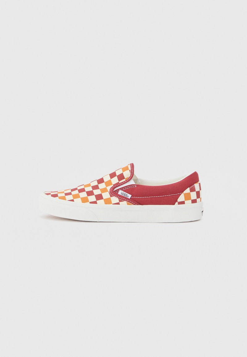 Red and orange checkerboard slip-on canvas sneaker with white rubber sole and stitching accents, featuring a branded tag on the side.