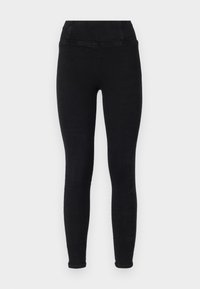 Leggings negros con una textura suave, cintura alta y corte ajustado, diseñados sin bolsillos ni patrones.