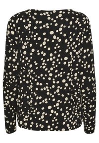 Black long-sleeve top featuring a white polka dot pattern, round neckline, and a relaxed fit, with a smooth texture and no visible fastenings.