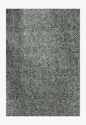 Textília s vzorom rybej kosti v čierno-bielych farbách, s textúrovaným vzhľadom z tkaniny.