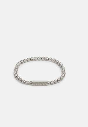 Metal bracelet with silver spherical beads and a rectangular centerpiece engraved with "BOSS." Smooth surface and rounded edges.