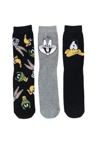 Tre paia di calzini con personaggi dei cartoni animati: a sinistra ci sono Bugs Bunny e Daffy Duck su uno sfondo nero, al centro un paio grigio con il volto di Bugs, a destra un paio nero con Daffy.