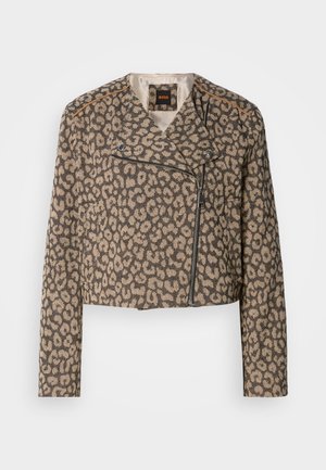 Cropped biker jacket in textured tan fabric with black leopard print. Features a diagonal zipper, notched collar, and two side pockets.